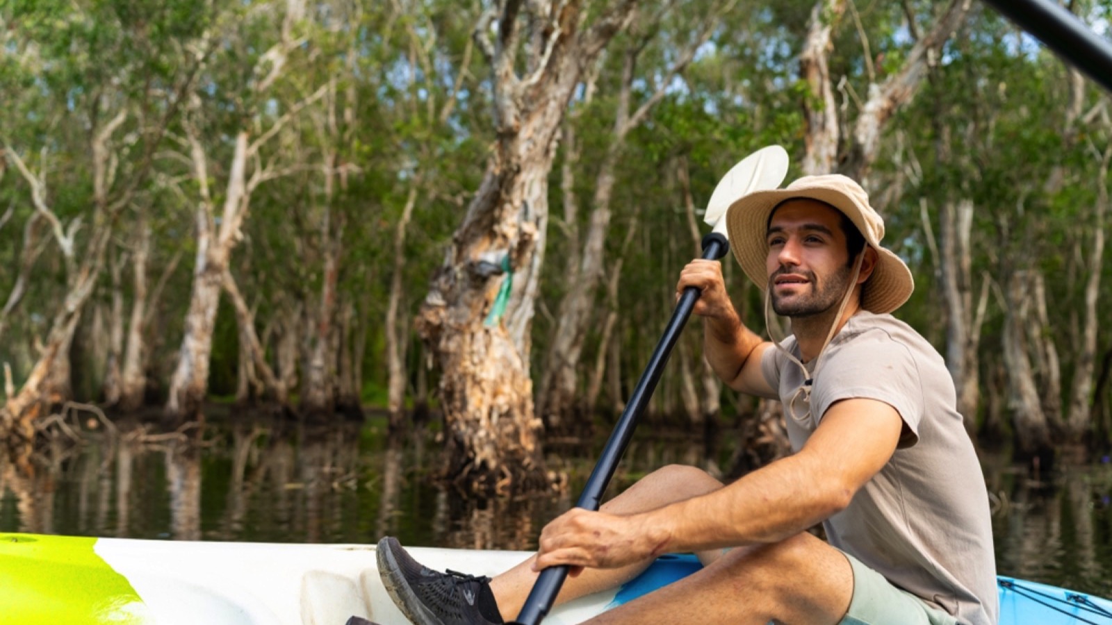 Handsome guy traveler canoeing